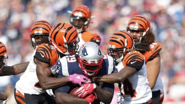 Oct 16, 2016; Foxborough, MA, USA; Cincinnati Bengals cornerback Adam Jones (24) and cornerback Josh Shaw (26) tackle New England Patriots running back LeGarrette Blount (29) during the third quarter at Gillette Stadium. Mandatory Credit: Greg M. Cooper-USA TODAY Sports