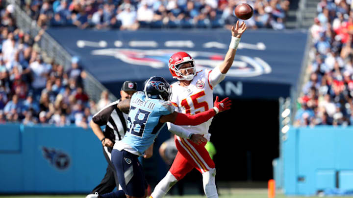 NASHVILLE, TENNESSEE - OCTOBER 24: Patrick Mahomes #15 of the Kansas City Chiefs throws a pass with his left hand while being chased by Harold Landry #58 of the Tennessee Titans in the third quarter in the game at Nissan Stadium on October 24, 2021 in Nashville, Tennessee. (Photo by Andy Lyons/Getty Images)