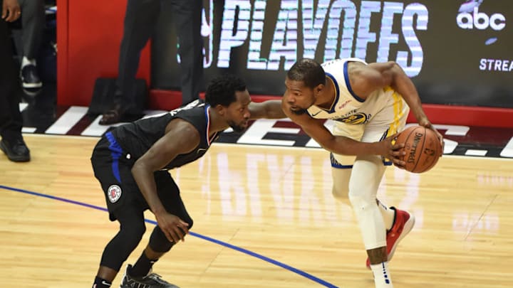 LOS ANGELES, CA - APRIL 21: Kevin Durant #35 of the Golden State Warriors guards the ball during the game against Patrick Beverley #21 of the LA Clippers during Game Four of Round One of the 2019 NBA Playoffs on April 21, 2019 at STAPLES Center in Los Angeles, California. NOTE TO USER: User expressly acknowledges and agrees that, by downloading and/or using this Photograph, user is consenting to the terms and conditions of the Getty Images License Agreement. Mandatory Copyright Notice: Copyright 2019 NBAE (Photo by Adam Pantozzi/NBAE via Getty Images)