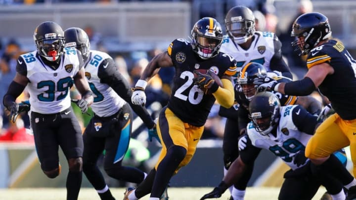 PITTSBURGH, PA - JANUARY 14: Le'Veon Bell #26 of the Pittsburgh Steelers runs with the ball against the Jacksonville Jaguars during the first half of the AFC Divisional Playoff game at Heinz Field on January 14, 2018 in Pittsburgh, Pennsylvania. (Photo by Kevin C. Cox/Getty Images)