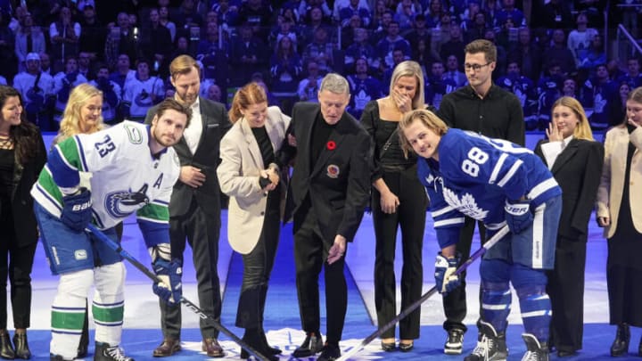 Nov 12, 2022; Toronto, Ontario, CAN; Toronto Maple Leafs alumni and Hall of Famer Borje Salming performs the ceremonial puck drop with Vancouver Canucks defenseman Oliver Ekman-Larsson (23) and Toronto Maple Leafs forward William Nylander (88) at Scotiabank Arena. Mandatory Credit: John E. Sokolowski-USA TODAY Sports