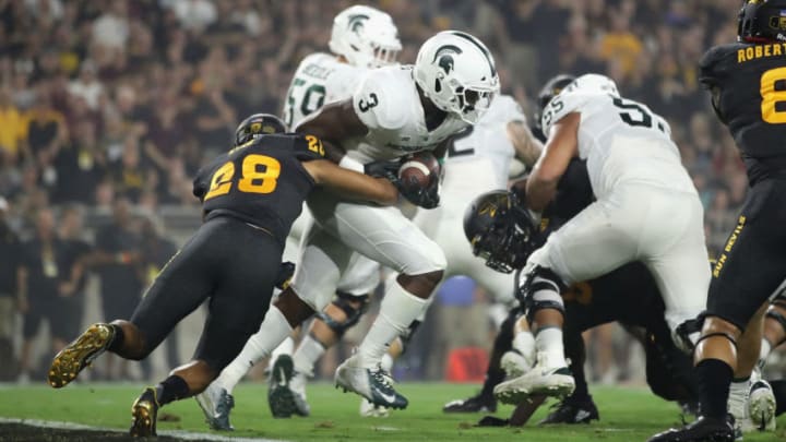 TEMPE, AZ - SEPTEMBER 08: Running back LJ Scott #3 of the Michigan State Spartans rushes the football past defensive back Demonte King #28 of the Arizona State Sun Devils during the college football game at Sun Devil Stadium on September 8, 2018 in Tempe, Arizona. The Sun Devils defeated the Spartans 16-13. (Photo by Christian Petersen/Getty Images)