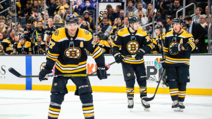 BOSTON, MA - OCTOBER 17: Boston Bruins center Patrice Bergeron (37), Boston Bruins left wing Jake DeBrusk (74), and Boston Bruins center Brad Marchand (63) skate to faceoff circle during the Tampa Bay Lightning and Boston Bruins NHL game on October 17, 2019, at TD Garden in Boston, MA. (Photo by John Crouch/Icon Sportswire via Getty Images)