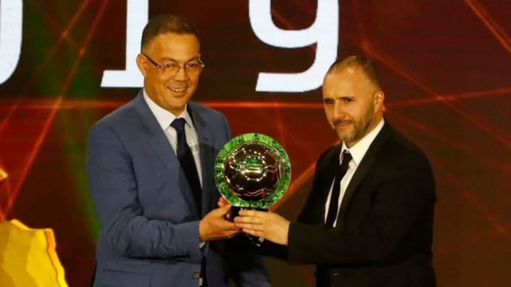 Djamel Belmadi (R), Algerian coach of the Algerian national team, is presented with the Men’s Coach of the Year trophy during the 2019 CAF Awards in the Egyptian resort town of Hurghada on January 7, 2020. (Photo by Khaled DESOUKI / AFP) (Photo by KHALED DESOUKI/AFP via Getty Images)