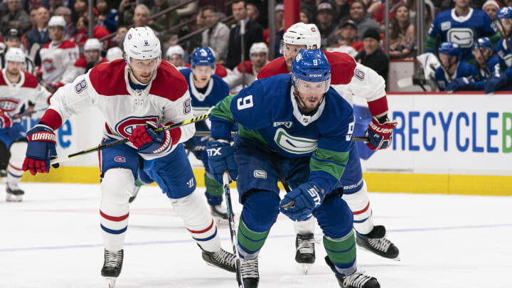 VANCOUVER, BC – DECEMBER 17: J.T. Miller #9 of the Vancouver Canucks chases down a loose puck after breaking free from Ben Chiarot #8 and Shea Weber #6 of the Montreal Canadiens during NHL action at Rogers Arena on December 17, 2019 in Vancouver, Canada. (Photo by Rich Lam/Getty Images)