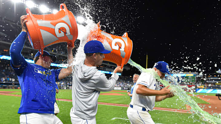 KANSAS CITY, MISSOURI - JULY 16: Starting pitcher Glenn Sparkman (right) of the Kansas City Royals is doused with Gatorade by Jakob Junis (left) and Danny Duffy after pitching a complete-game shutout against the Chicago White Sox at Kauffman Stadium on July 16, 2019 in Kansas City, Missouri. The Royals won 11-0. (Photo by Ed Zurga/Getty Images)