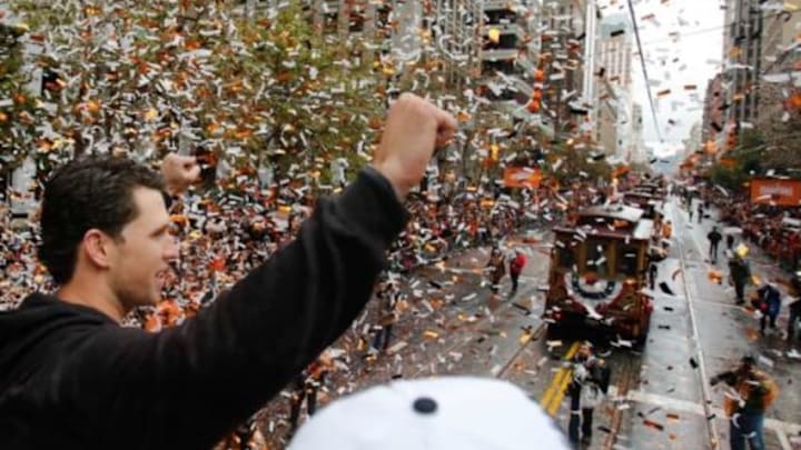 Oct 31, 2014; San Francisco, CA, USA; San Francisco Giants catcher Buster Posey (28) waves to the crowd during the World Series victory parade on Market Street. Mandatory Credit: Kelley L Cox-USA TODAY Sports