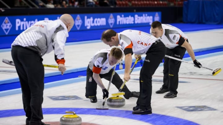 (From L) World Champion Canada's team: skip Kevin Koe, third Marc Kennedy, second Brent Laing and lead Ben Hebert competes during the gold medal game against Denmark at the World Men's Curling Championships on April 10, 2016 in Basel. / AFP / FABRICE COFFRINI (Photo credit should read FABRICE COFFRINI/AFP/Getty Images)