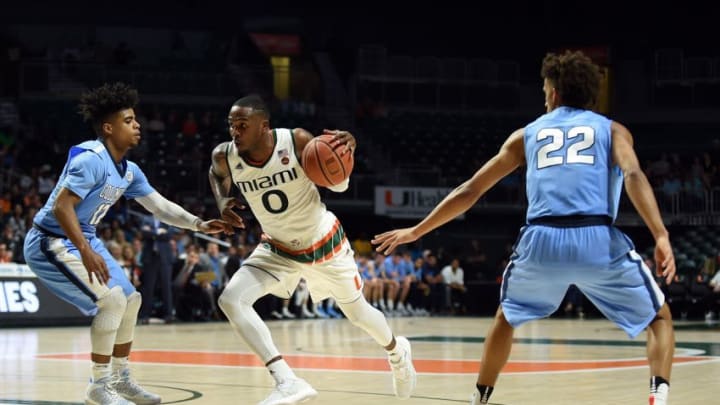 Dec 28, 2016; Coral Gables, FL, USA; Columbia Lions guard Mike Smith (12) applies pressure to Miami Hurricanes guard Ja'Quan Newton (0) as Columbia guard Nate Hickman (22) defends during the second half at Watsco Center. Mandatory Credit: Steve Mitchell-USA TODAY Sports