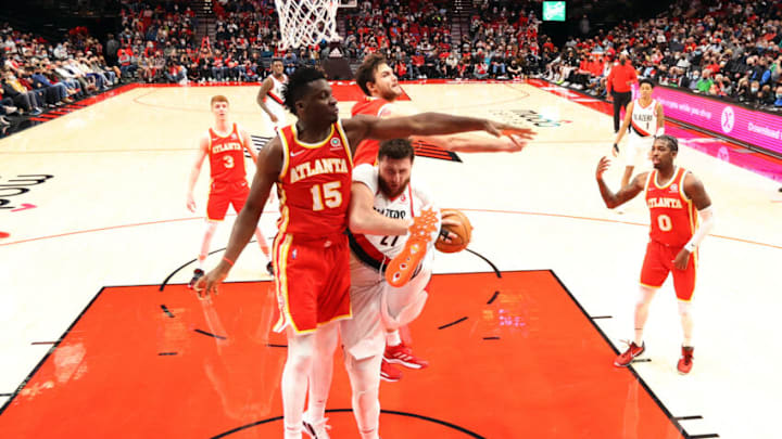 PORTLAND, OREGON - JANUARY 03: Jusuf Nurkic #27 of the Portland Trail Blazers grabs a rebound against Clint Capela #15 of the Atlanta Hawks during the second half at Moda Center on January 03, 2022 in Portland, Oregon. NOTE TO USER: User expressly acknowledges and agrees that, by downloading and or using this photograph, User is consenting to the terms and conditions of the Getty Images License Agreement. (Photo by Abbie Parr/Getty Images)