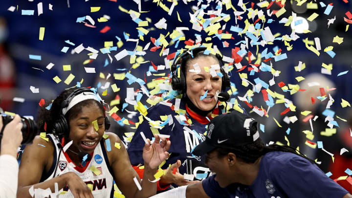SAN ANTONIO, TEXAS – MARCH 29: Aari McDonald #2 and head coach Adia Barnes of the Arizona Wildcats are showered with confetti after the win over the Indiana Hoosiers during the Elite Eight round of the NCAA Women’s Basketball Tournament at the Alamodome on March 29, 2021 in San Antonio, Texas.The Arizona Wildcats defeated the Indiana Hoosiers 66-53 to advance to the Final Four. (Photo by Elsa/Getty Images)