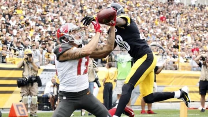 Sep 28, 2014; Pittsburgh, PA, USA; Tampa Bay Buccaneers wide receiver Mike Evans (13) catches a seven yard touchdown pass against Pittsburgh Steelers cornerback Cortez Allen (28) during the first quarter at Heinz Field. Mandatory Credit: Charles LeClaire-USA TODAY Sports