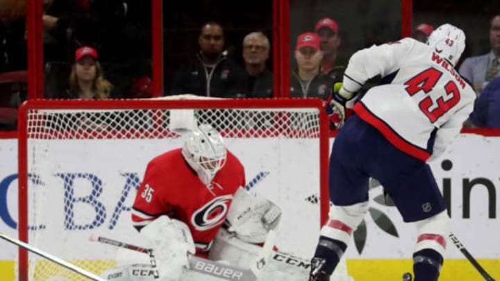 RALEIGH, NC – MARCH 28: Tom Wilson #43 of the Washington Capitals fires a shot on goal and Curtis McElhinney #35 of the Carolina Hurricanes makes the save during an NHL game on March 28, 2019 at PNC Arena in Raleigh, North Carolina. (Photo by Gregg Forwerck/NHLI via Getty Images)