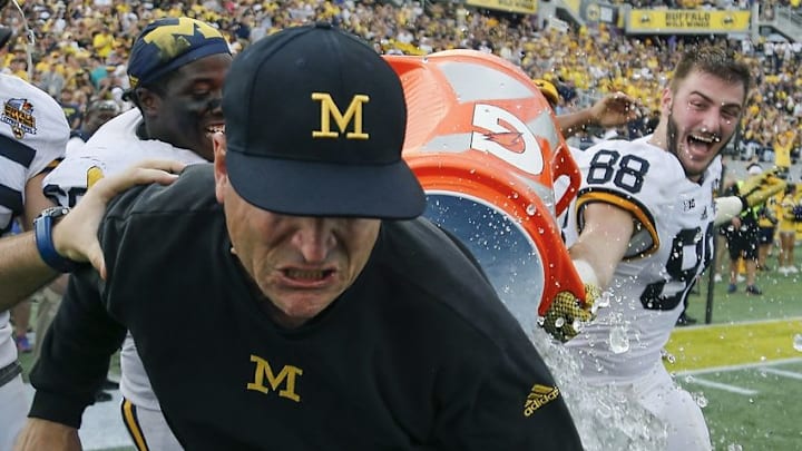 Jan 1, 2016; Orlando, FL, USA; Michigan Wolverines head coach Jim Harbaugh gets a Gatorade bath after the Michigan Wolverines defeated the Florida Gators 41-7 in the 2016 Citrus Bowl at Orlando Citrus Bowl Stadium. Mandatory Credit: Reinhold Matay-USA TODAY Sports