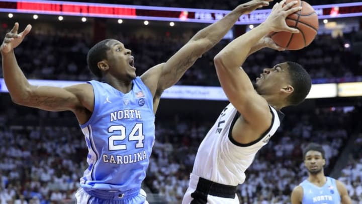 LOUISVILLE, KENTUCKY - FEBRUARY 02: Kenny Williams #24 of the North Carolina Tar Heels defends the shot of Christen Cunningham #1 of the Louisville Cardinals at KFC YUM! Center on February 02, 2019 in Louisville, Kentucky. (Photo by Andy Lyons/Getty Images)