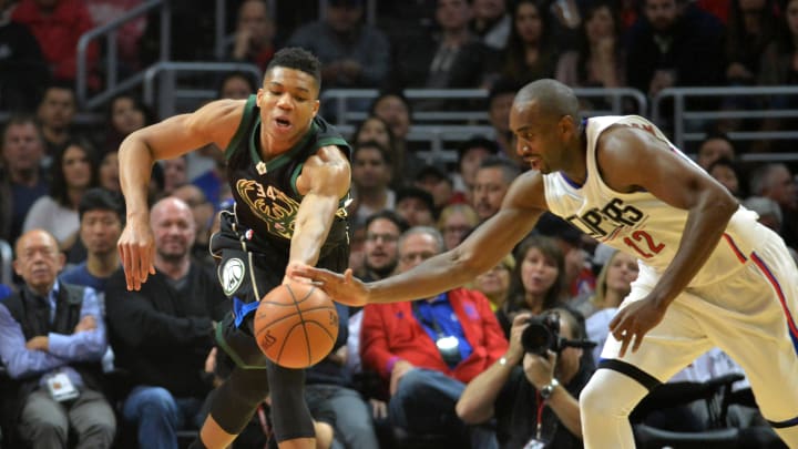 Dec 16, 2015; Los Angeles, CA, USA; Milwaukee Bucks forward Giannis Antetokounmpo (34) and Los Angeles Clippers forward Luc Richard Mbah a Moute (12) reach for the ball during an NBA basketball game at Staples Center. Mandatory Credit: Kirby Lee-USA TODAY Sports