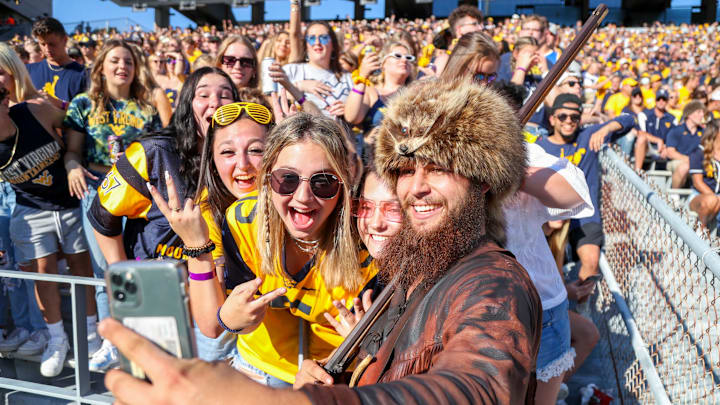 Sep 11, 2021; Morgantown, West Virginia, USA; The West Virginia Mountaineers mascot takes a photo with students during the first quarter against the Long Island Sharks at Mountaineer Field at Milan Puskar Stadium. Mandatory Credit: Ben Queen-USA TODAY Sports