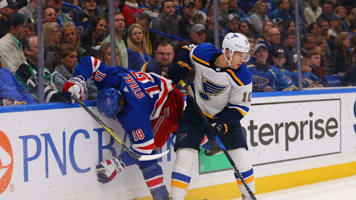 ST. LOUIS, MO - MARCH 17: Brayden Schenn #10 of the St. Louis Blues knocks Marc Staal #18 of the New York Rangers off the puck at the Scottrade Center on March 17, 2018 in St. Louis, Missouri. (Photo by Dilip Vishwanat/Getty Images)