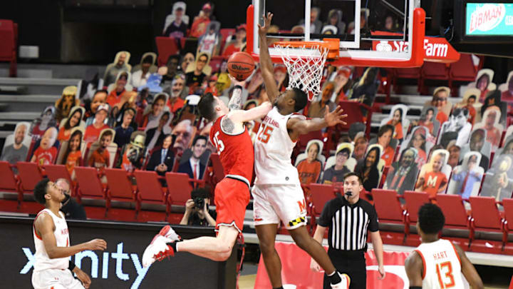 COLLEGE PARK, MD - FEBRUARY 08: Kyle Young #25 of the Ohio State Buckeyes drives to the basket over Jairus Hamilton #25 of the Maryland Terrapins during a college basketball game at Xfinity Center on February 8, 2021 in College Park, Maryland. (Photo by Mitchell Layton/Getty Images)