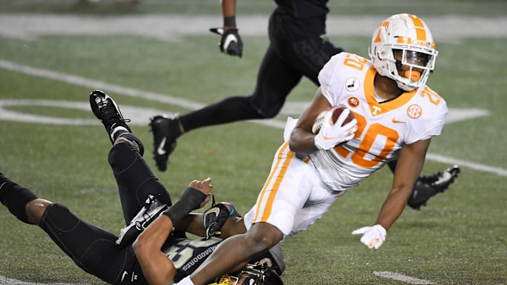 Tennessee running back Jabari Small (20) runs over Vanderbilt cornerback Jaylen Mahoney (23) during the fourth quarter at Vanderbilt Stadium Saturday, Dec. 12, 2020 in Nashville, Tenn.Gw56747