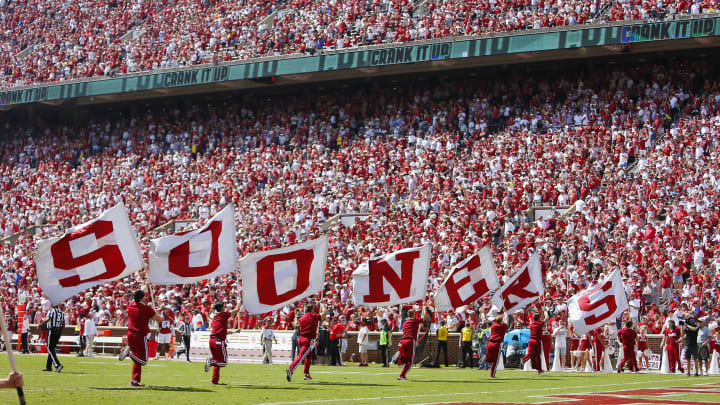 NORMAN, OK – SEPTEMBER 18: Oklahoma Sooners cheerleaders run across the field with Sooners flags after a 100-yard return on a blocked point-after-touchdown for two points against the Nebraska Cornhuskers at Gaylord Family Oklahoma Memorial Stadium on September 18, 2021 in Norman, Oklahoma. Oklahoma won 23-16. (Photo by Brian Bahr/Getty Images)