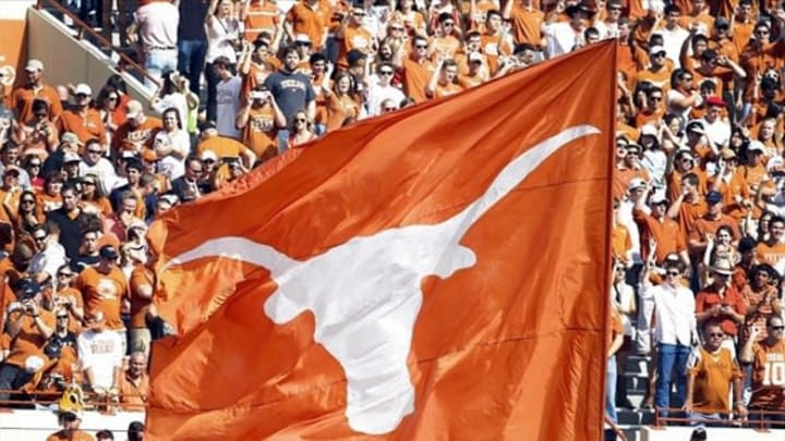 Nov 10, 2012; Austin, TX, USA; Texas Longhorns cheerleaders wave a flag after a touchdown against the Iowa State Cyclones in the first quarter at Darrell K Royal-Texas Memorial Stadium. Mandatory Credit: Brett Davis-USA TODAY Sports