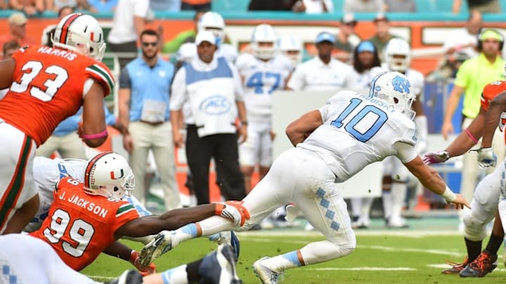 Oct 15, 2016; Miami Gardens, FL, USA; Miami Hurricanes defensive lineman Joe Jackson (99) brings down North Carolina Tar Heels quarterback Mitch Trubisky (10) during the first half at Hard Rock Stadium. Mandatory Credit: Jasen Vinlove-USA TODAY Sports