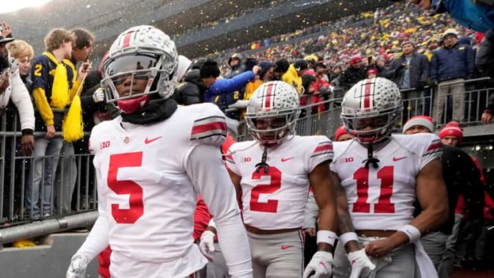 Ohio State Buckeyes wide receivers Garrett Wilson (5), Chris Olave (2) and Jaxon Smith-Njigba (11) take the the field for the NCAA football game against the Michigan Wolverines at Michigan Stadium in Ann Arbor on Sunday, Nov. 28, 2021.Ohio State Buckeyes At Michigan Wolverines