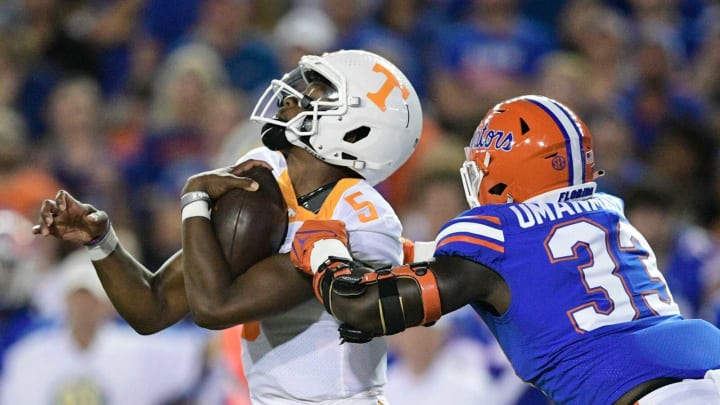 Tennessee quarterback Hendon Hooker (5) is tackled by Florida defensive lineman Princely Umanmielen (33) during the first quarter of an NCAA football game against Florida at Ben Hill Griffin Stadium in Gainesville, Florida on Saturday, Sept. 25, 2021.Tennflorida0925 0825