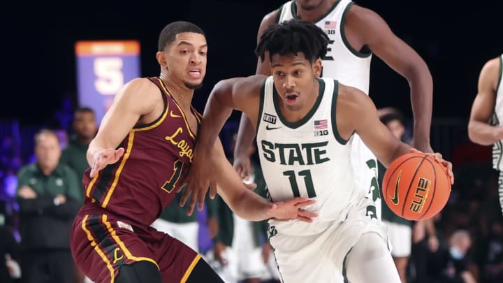 Nov 24, 2021; Nassau, BHS; Michigan State Spartans guard A.J. Hoggard (11) dribbles as Loyola Ramblers guard Lucas Williamson (1) defends during the first half of the 2021 Battle 4 Atlantis Tournament at Imperial Arena. Mandatory Credit: Kevin Jairaj-USA TODAY Sports