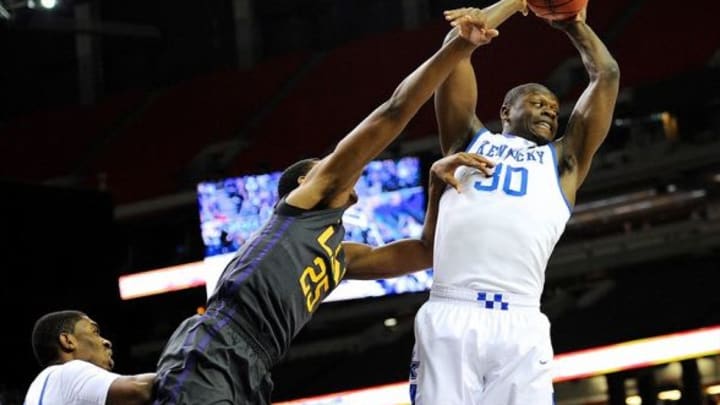 Mar 14, 2014; Atlanta, GA, USA; Kentucky Wildcats forward Julius Randle (30) grabs a rebound over LSU Tigers forward Jordan Mickey (25) during the first half in the quarterfinals of the SEC college basketball tournament at Georgia Dome. Mandatory Credit: Dale Zanine-USA TODAY Sports