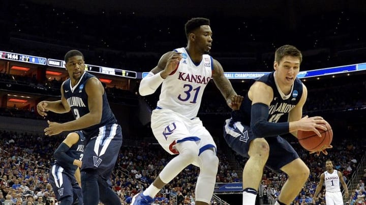 Mar 26, 2016; Louisville, KY, USA; Villanova Wildcats guard Ryan Arcidiacono (15) grabs a loose ball against Kansas Jayhawks forward Jamari Traylor (31) during the first half of the south regional final of the NCAA Tournament at KFC YUM!. Mandatory Credit: Jamie Rhodes-USA TODAY Sports