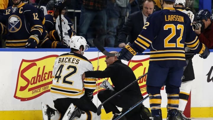 Dec 29, 2016; Buffalo, NY, USA; Boston Bruins right wing David Backes (42) is attended to by a trainer during the first period against the Buffalo Sabres at KeyBank Center. Mandatory Credit: Timothy T. Ludwig-USA TODAY Sports