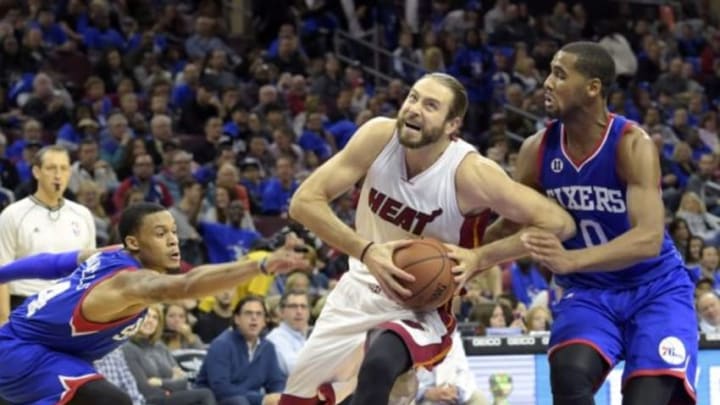 Nov 1, 2014; Philadelphia, PA, USA; Miami Heat forward Josh McRoberts (4) drives past Philadelphia 76ers forward Brandon Davies (0) and guard K.J. McDaniels (14) during the second half at Wells Fargo Center. The Heat defeated the 76ers, 114-96. Mandatory Credit: Eric Hartline-USA TODAY Sports