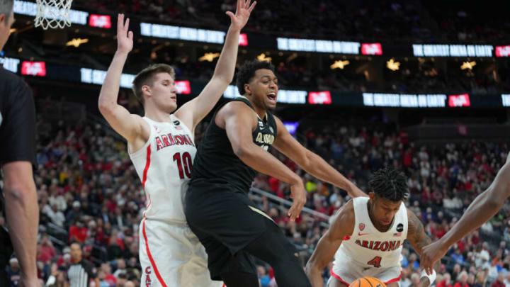Mar 11, 2022; Las Vegas, NV, USA; Colorado Buffaloes forward Evan Battey (21) loses the ball to Arizona Wildcats guard Dalen Terry (4) as Arizona Wildcats forward Azuolas Tubelis (10) defends during the first half at T-Mobile Arena. Mandatory Credit: Stephen R. Sylvanie-USA TODAY Sports