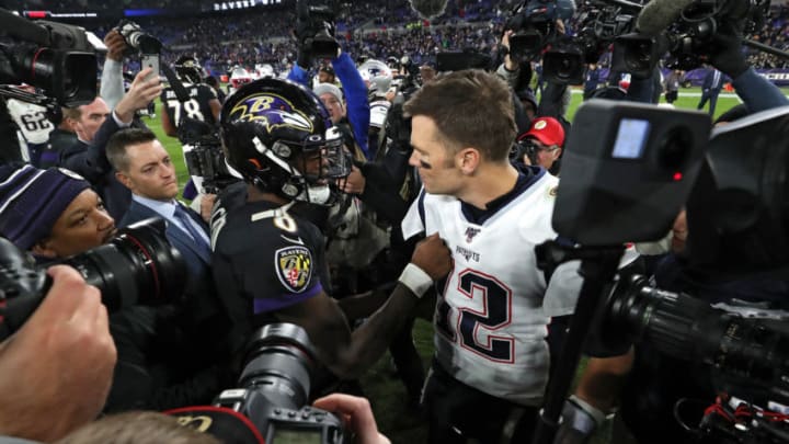 BALTIMORE, MARYLAND - NOVEMBER 03: Quarterback Lamar Jackson #8 of the Baltimore Ravens and quarterback Tom Brady #12 of the New England Patriots talk after the Ravens defeated the Patriots at M&T Bank Stadium on November 3, 2019 in Baltimore, Maryland. (Photo by Todd Olszewski/Getty Images)
