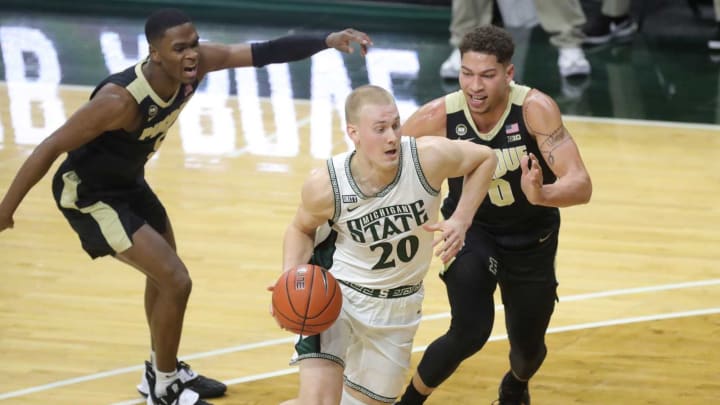 Michigan State Spartans forward Joey Hauser drives against Purdue Boilermakers forward Mason Gillis during the first half at Breslin Center in East Lansing, Friday, Jan. 8, 2021.Msu Purdue