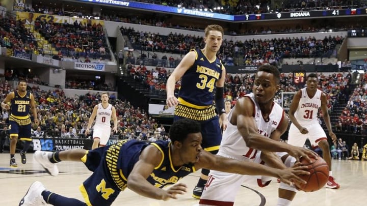 Mar 11, 2016; Indianapolis, IN, USA; Indiana Hoosiers guard Yogi Ferrell (11) scrambles for a loose ball against Michigan Wolverines guard Derrick Walton Jr. (10) during the Big Ten Conference tournament at Bankers Life Fieldhouse. Michigan wins 72-69. Mandatory Credit: Brian Spurlock-USA TODAY Sports