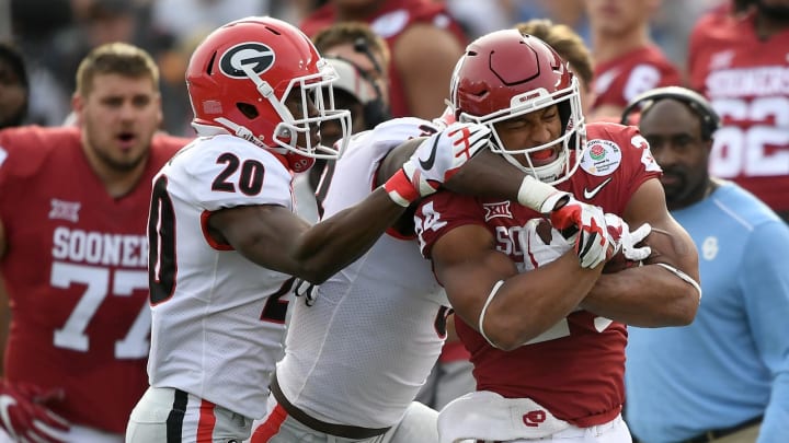 PASADENA, CA – JANUARY 01: Running back Rodney Anderson #24 of the Oklahoma Sooners runs the ball against defensive back J.R. Reed #20 of the Georgia Bulldogs in the first half in the 2018 College Football Playoff Semifinal at the Rose Bowl Game presented by Northwestern Mutual at the Rose Bowl on January 1, 2018 in Pasadena, California. (Photo by Kevork Djansezian/Getty Images)