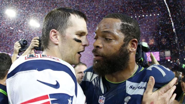GLENDALE, AZ - FEBRUARY 01: Tom Brady #12 of the New England Patriots is congratulated by Michael Bennett #72 of the Seattle Seahawks after Super Bowl XLIX at University of Phoenix Stadium on February 1, 2015 in Glendale, Arizona. The Patriots defeated the Seahawks 28-24. (Photo by Tom Pennington/Getty Images)
