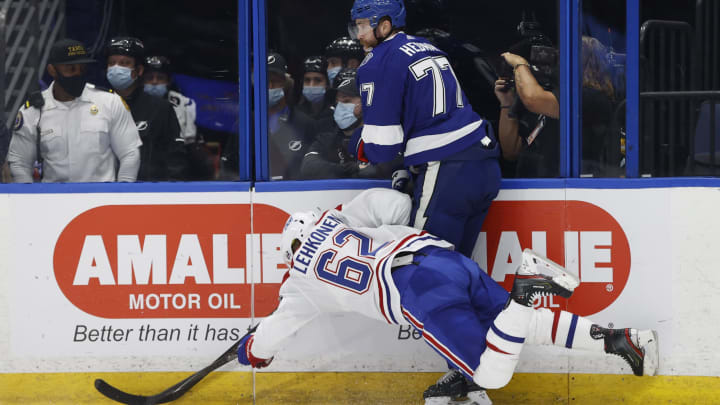 Jun 28, 2021; Tampa, Florida, USA; Montreal Canadiens left wing Artturi Lehkonen (62) falls while chasing the puck with Tampa Bay Lightning defenseman Victor Hedman (77) in the first period of game one of the 2021 Stanley Cup Final at Amalie Arena. Mandatory Credit: Kim Klement-USA TODAY Sports
