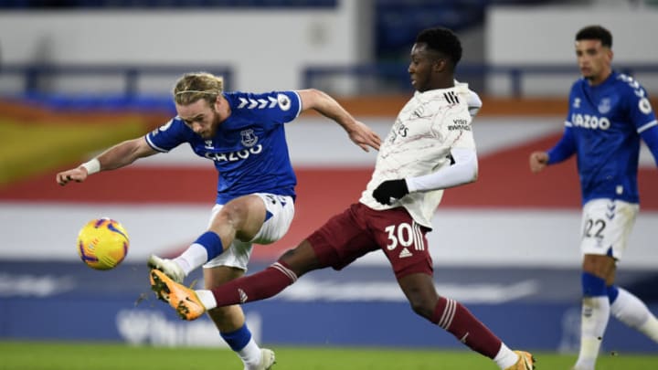 LIVERPOOL, ENGLAND - DECEMBER 19: Tom Davies of Everton is challenged by Eddie Nketiah of Arsenal during the Premier League match between Everton and Arsenal at Goodison Park on December 19, 2020 in Liverpool, England. A limited number of fans (2000) are welcomed back to stadiums to watch elite football across England. This was following easing of restrictions on spectators in tiers one and two areas only. (Photo by Peter Powell -