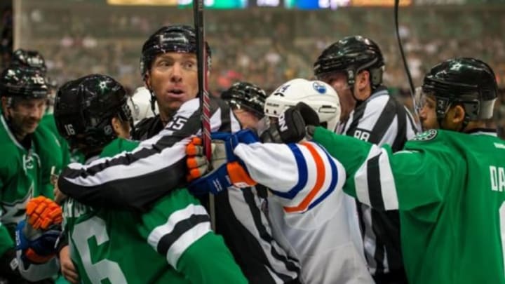 Nov 25, 2014; Dallas, TX, USA; NHL linesman Pierre Racicot (65) breaks up a fight between Dallas Stars left wing Ryan Garbutt (16) and Edmonton Oilers right wing Jordan Eberle (14) during the third period at the American Airlines Center. The Stars defeated the Oilers 3-2. Mandatory Credit: Jerome Miron-USA TODAY Sports