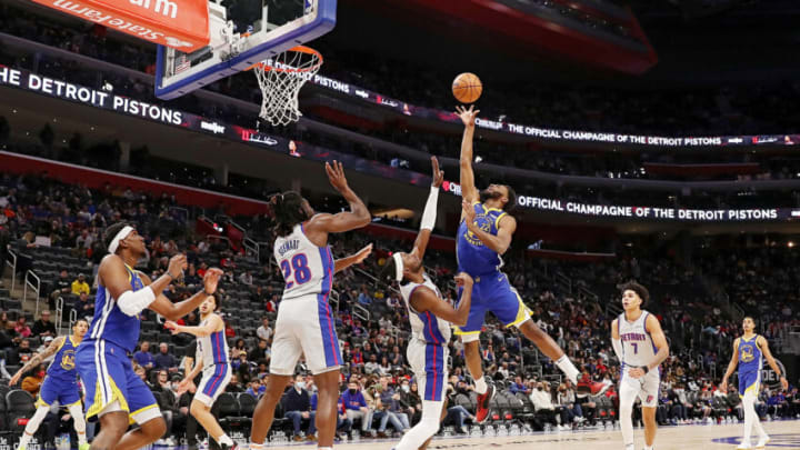 Andrew Wiggins #22 of the Golden State Warriors goes up for a layup against Jerami Grant #9 of the Detroit Pistons (Photo by Mike Mulholland/Getty Images)