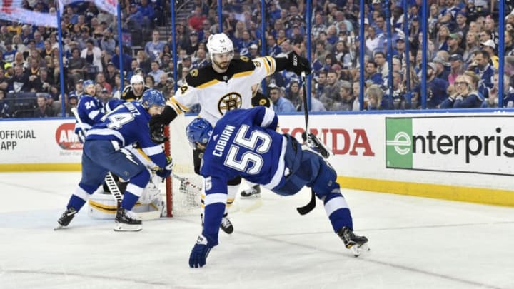 TAMPA, FL - APRIL 30: Tampa Bay Lightning defender Braydon Coburn (55) is tripped up by Boston Bruins defender Adam McQuaid (54) during the second period of an NHL Stanley Cup Eastern Conference Playoffs game between the Boston Bruins and the Tampa Bay Lightning on April 30, 2018, at Amalie Arena in Tampa, FL. (Photo by Roy K. Miller/Icon Sportswire via Getty Images)