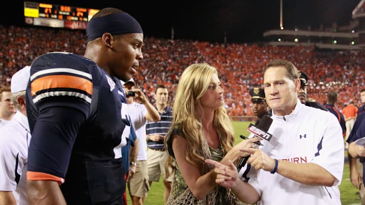 AUBURN, AL – SEPTEMBER 18: Quarterback Cameron Newton #2 of the Auburn Tigers waits as Erin Andrews finishes her interview with head coach Gene Chizik after their 27-24 overtime win over the Clemson Tigers at Jordan-Hare Stadium on September 18, 2010 in Auburn, Alabama. (Photo by Kevin C. Cox/Getty Images)