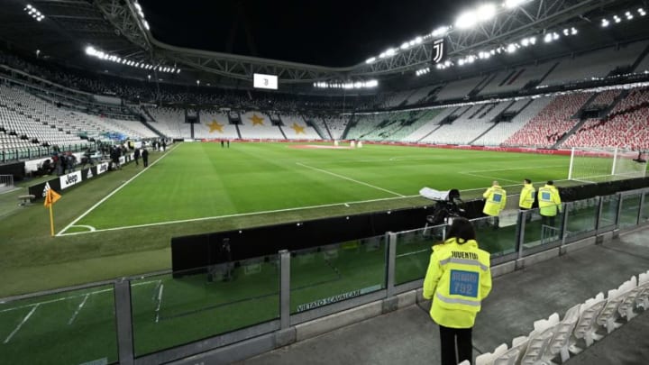 A stadium steward looks at the empty Juventus stadium before the Italian Serie A football match Juventus vs Inter Milan which will be played behind closed doors, in Turin on March 8, 2020. - Italy on March 8, 2020, had the second-highest coronavirus toll in the world, after reporting a sharp jump in both deaths and number of infected people, according to an AFP count. The number of fatalities shot up by 133 to 366 on March 8, while the number of infections rose by a single-day record of 1,492 to hit 7,375, its civil protection agency said. (Photo by Vincenzo PINTO / AFP) (Photo by VINCENZO PINTO/AFP via Getty Images)