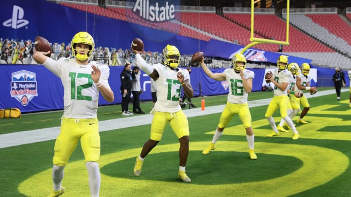 GLENDALE, ARIZONA – JANUARY 02: Quarterbacks (L-R) Tyler Shough #12, Anthony Brown #13 and Bradley Yaffe #16 of the Oregon Ducks warm up before the PlayStation Fiesta Bowl against the Iowa State Cyclones at State Farm Stadium on January 02, 2021 in Glendale, Arizona. The Cyclones defeated the Ducks 34-17. (Photo by Christian Petersen/Getty Images)