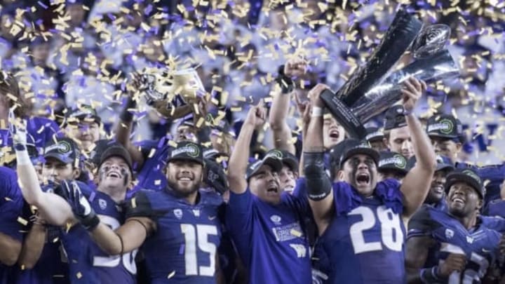 December 2, 2016; Santa Clara, CA, USA; Washington Huskies linebacker Psalm Wooching (28) hoists the championship trophy after the Pac-12 championship against the Colorado Buffaloes at Levi