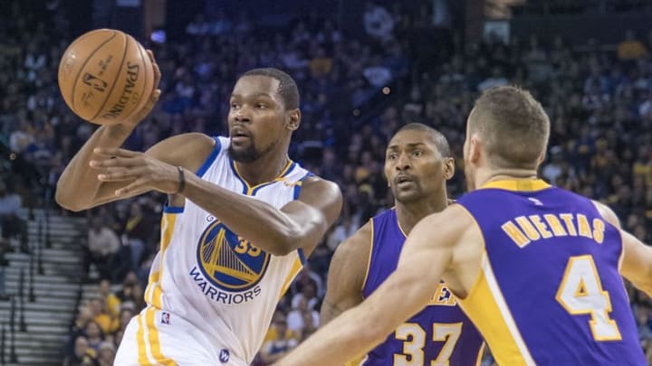 November 23, 2016; Oakland, CA, USA; Golden State Warriors forward Kevin Durant (35) passes the basketball against Los Angeles Lakers forward Metta World Peace (37) and guard Marcelo Huertas (4) during the fourth quarter at Oracle Arena. The Warriors defeated the Lakers 149-106. Mandatory Credit: Kyle Terada-USA TODAY Sports